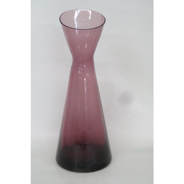 This beautiful and compact slant vase is made of a striking burgundy / amethyst colored lead glass. We believe this...