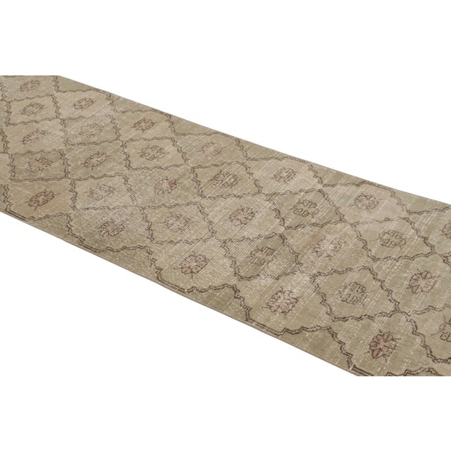 This vintage runner rug is a 3x10 Turkish distressed piece, made with hand-knotted wool circa mid-20th century. It is an...