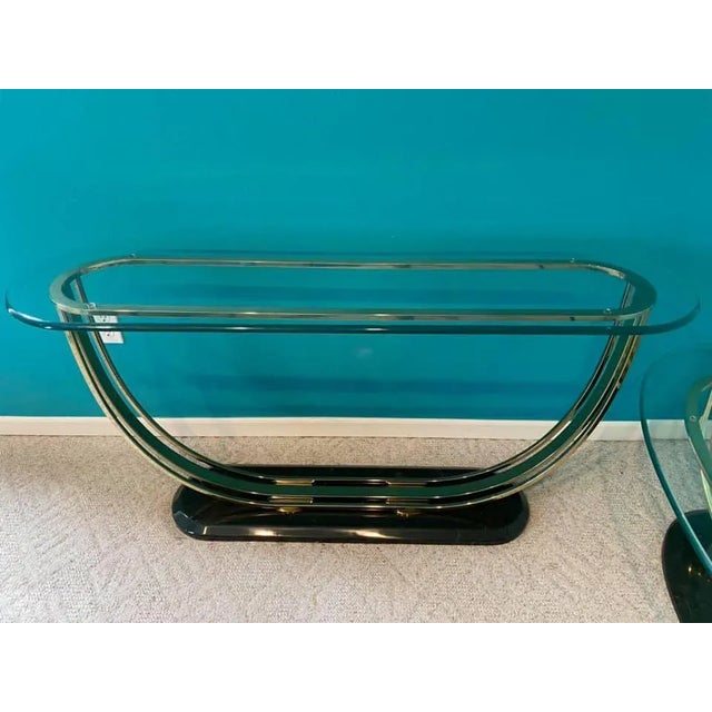 I have a stunning Vintage Designer Brass and Glass Console Table with a heavy Marble Base. This shiny brass frame is...