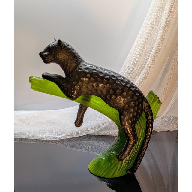 Elegant black panther resting on a green branch, stunningly rendered in pate de verre glass by French maker, Daum. Pate de...