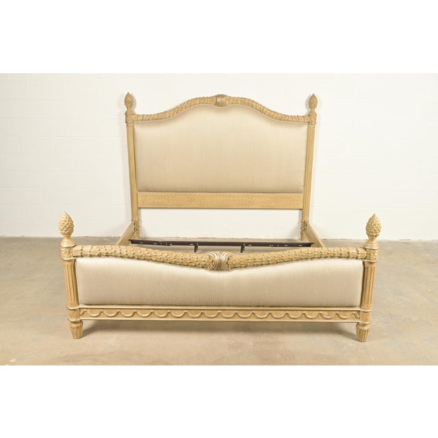 A stylish French Regency Louis XVI style king size bed frame In the manner of Henredon USA, Circa Late 20th Century Carved...