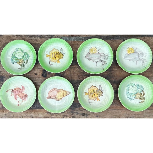 This set of eight Italian seafood plates delights with a fluted, shallow-dished silhouette, each rim finely ribbed in...