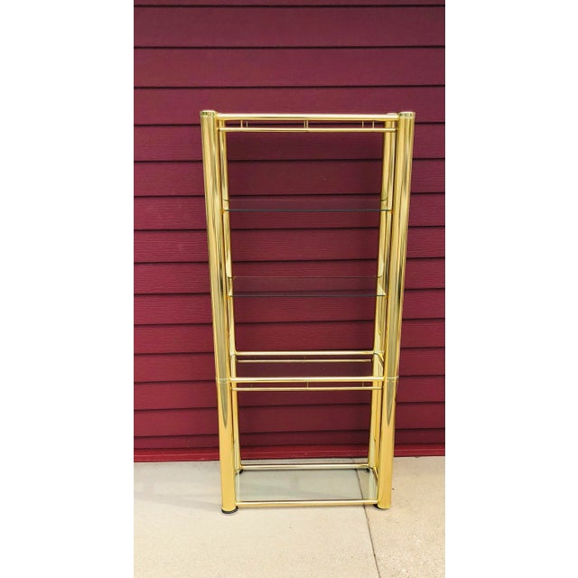 Vintage Milo Baughman style brass Etagere. 5 glass shelves, 2 removable, 3 permanent. In overall great condition. Some...
