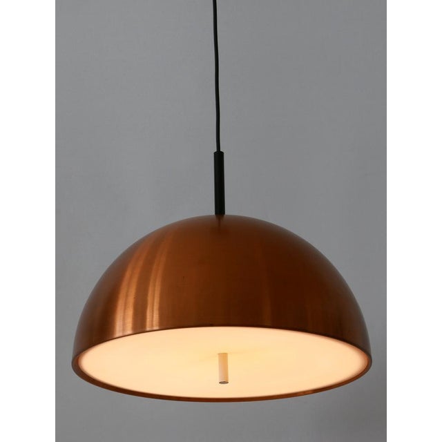 Minimalistic and elegant mid-century modern copper pendant lamp or hanging light. Designed and manufactured by staff &...