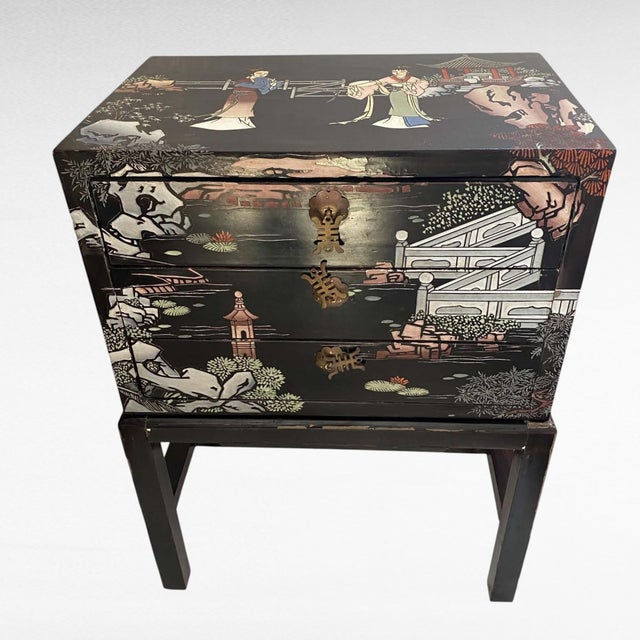 Mid-20th-century Chinese Chinoiserie black lacquer 3-drawer jewelry or collector cabinet set on its custom-fitted elevated...