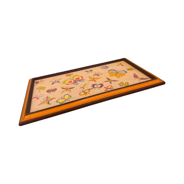 This vibrant vintage needlepoint features a whimsical collection of multi-colored butterflies hand-stitched on a neutral...