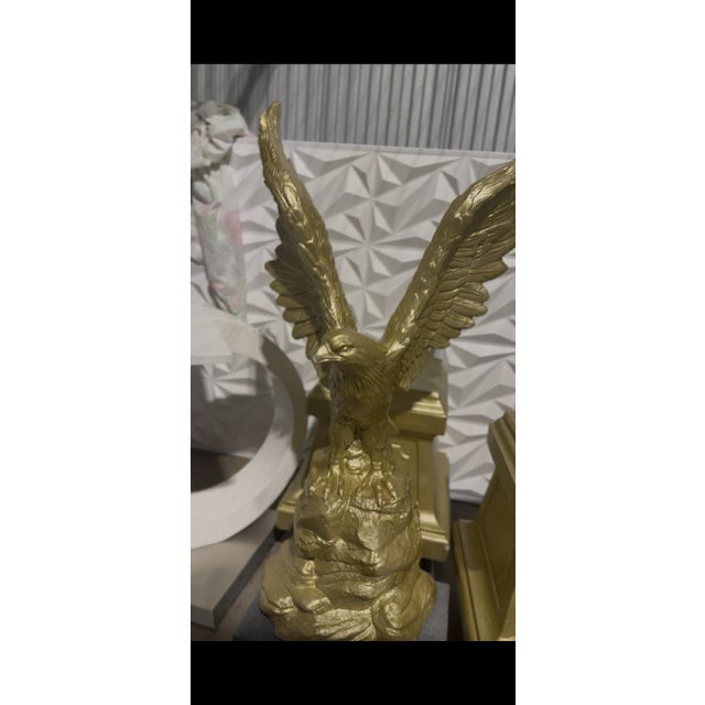 This is a true mirrored pair of monumental cast concrete American eagle statues mounted on their original rolling plinth...