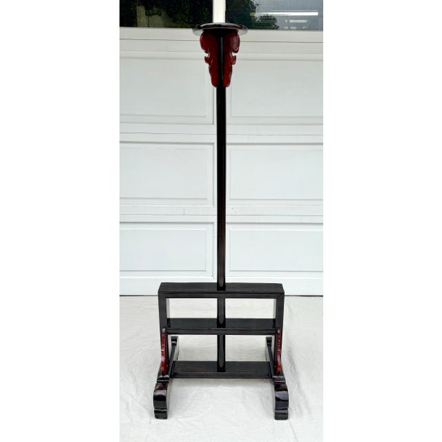 Here is a striking pair of antique Chinese elmwood lantern stands, crafted in the traditional Shanxi provincial style and...