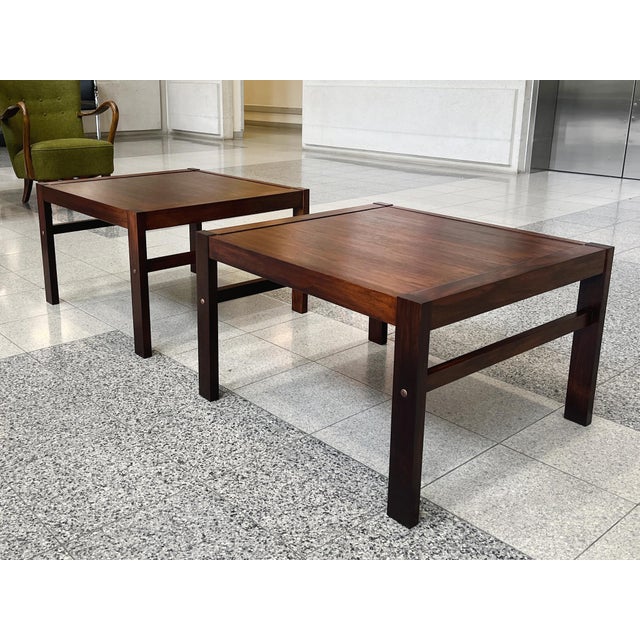 A classic pair of Danish Modern rosewood tables in the style of France & Søn. A design that feels effortless, sleek lines...