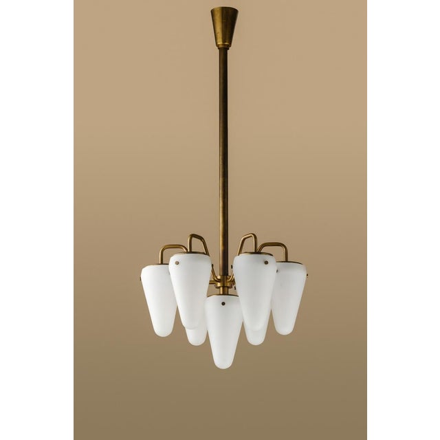 Rare and early seven-armed pendant in brass and opaline glass shades. Produced by Hans-Agne Jakobsson AB in Markaryd,...