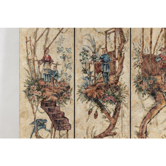 This vintage four-panel folding screen features an ornate painted surface depicting whimsical chinoiserie scenes across...