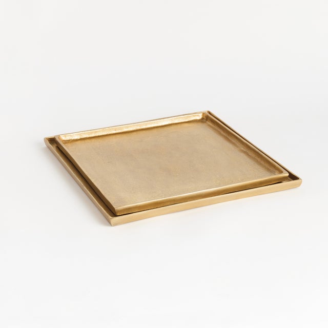 A geometric shape and sleek look make these shallow cast aluminum trays unique. Line with a collection of candles for a...