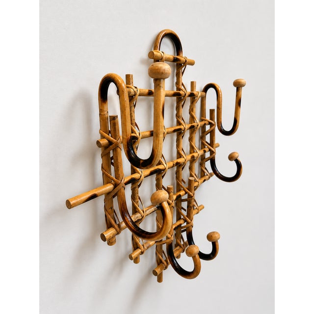 Bring timeless European charm to your entryway, mudroom, bedroom, or bath with this vintage burnt bamboo wall coat rack....