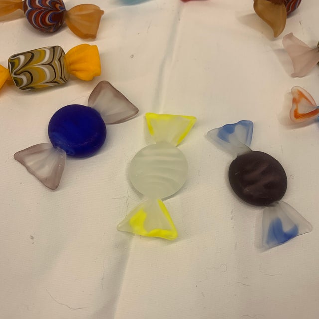 Offered here is a set of ten glass candies.