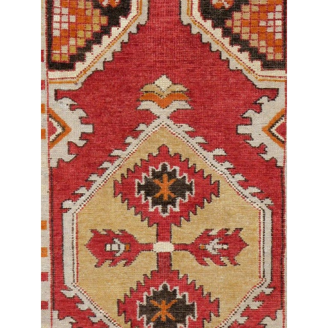 A vintage Turkish Oushak throw rug handmade during the mid-20th century with a red field and ivory border. Measures: 2' 8"...