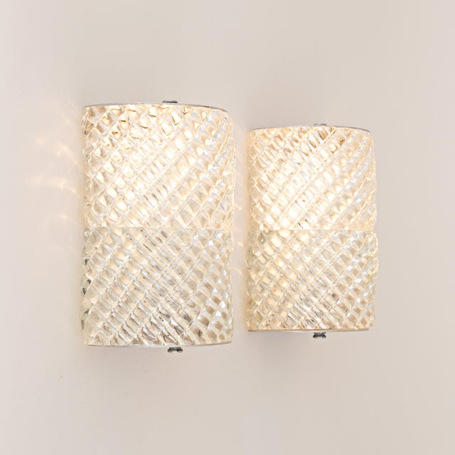 Stunning pair of authentic 1950s Murano Glass Wall Sconces. Likely made by the company Barovier & Toso, that 8is renowed...