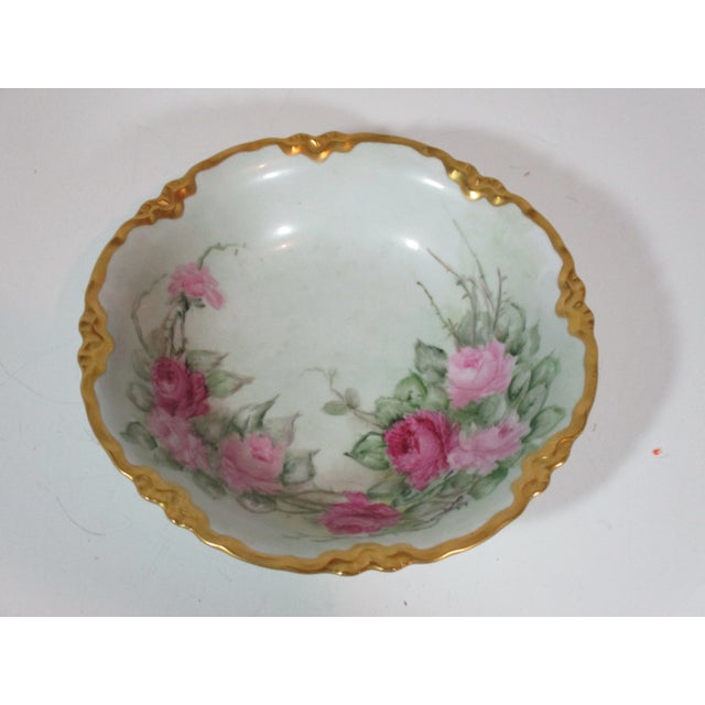 Decorative hand painted German fruit bowl. The bowl has a mint green interior background with sprays of light and dark...