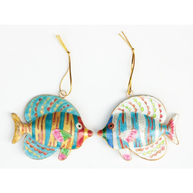 Pair of cloisonné enameled fish on gold metallic thread. Coloration may vary based on the nature of the materials and...