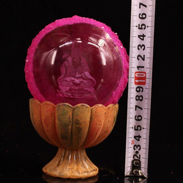 This is a rare and unusual Buddhist relic sphere, described as a "regenerated sarira" containing an etched image of a...