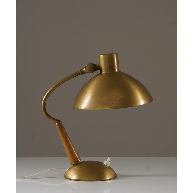 Beautiful swedish modern table lamp in brass and wood by malmö metallvarufabrik, 1940s. This lamp offers a simple, elegant...