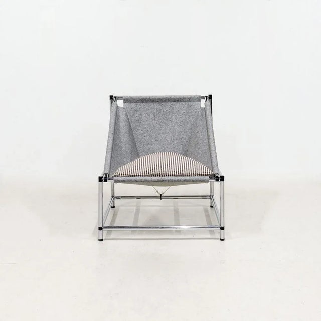 A pair of armchairs with chrome tube bases, felt shell seat. Italy, 90s.