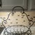 This basket is made out of/iron ornate scrollwork and handle, beautiful oval shape base to display, and it is footed....