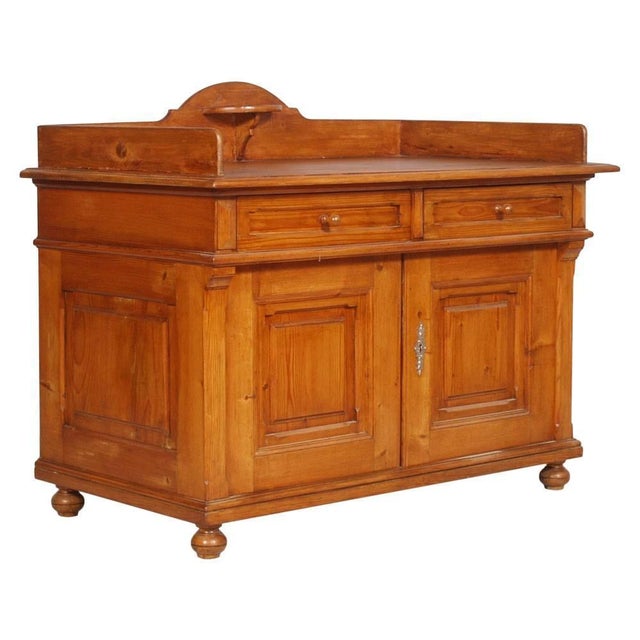 Elegant tyrolean sideboard in solid larch wood, dating to the early 20th century, distinguished by its warm natural tone,...