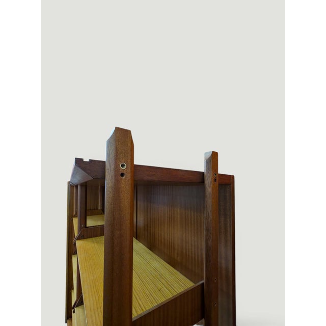 "Italian modular wall unit attributed to Vittorio Dassi, produced in the 1960s. The piece combines open shelving and a...