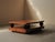 Impressive rectangular coffee table features a bold geometric composition, resting on a box-form base and a detached top...