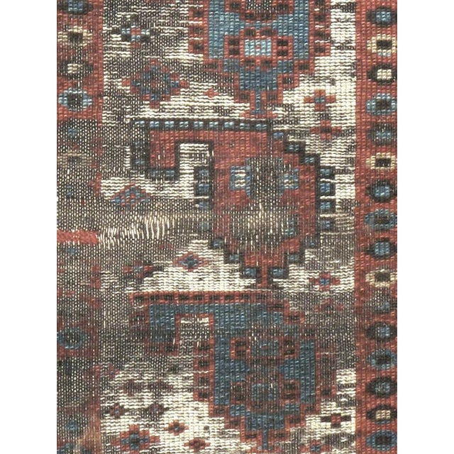 An antique Caucasian Kazak carpet with a weathered and distressed appeal from the turn of the 20th century. This shabby...
