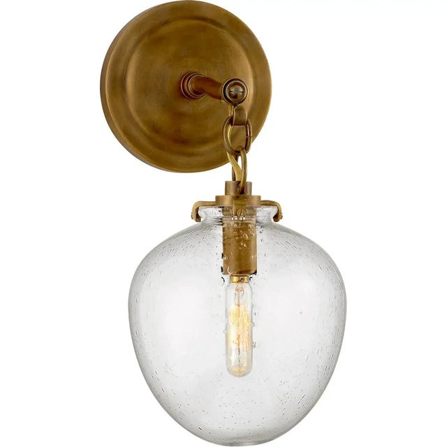 Katie Small Acorn Sconce in Hand-Rubbed Antique Brass with Seeded Glass Designer: Thomas O'Brien Height: 13.4" Extension:...