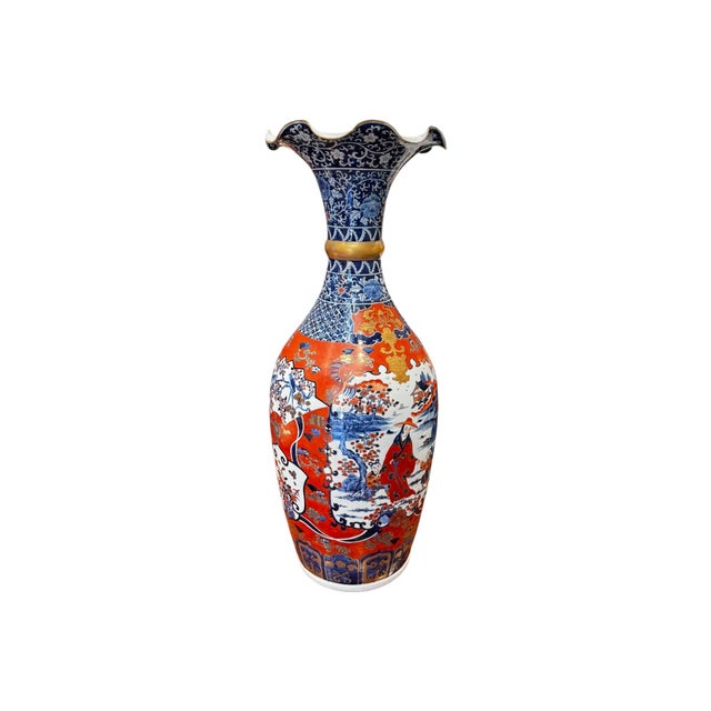 A stunning vintage Japanese Imari porcelain vase featuring the rich colors and intricate hand-decorated scenes that have...