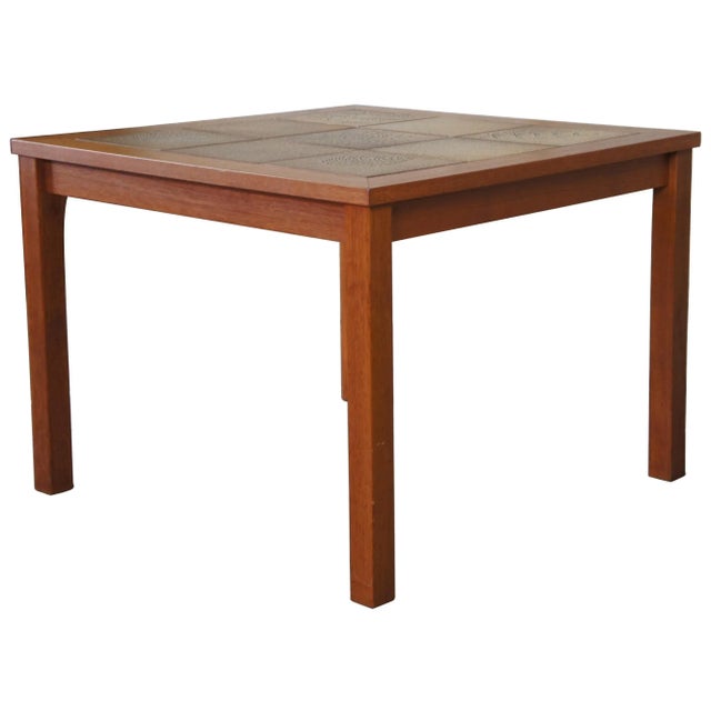 Danish modern square teak side accent table. Made of teak wood featuring a floral / leaf motif tiled top.