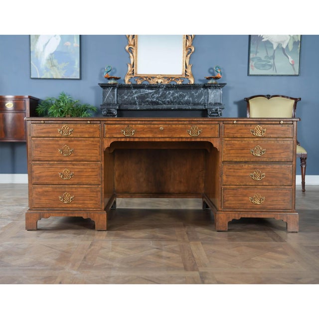 A fine quality Vintage Baker Walnut Executive Desk with a richly tooled leather top and beautifully herringbone banded...