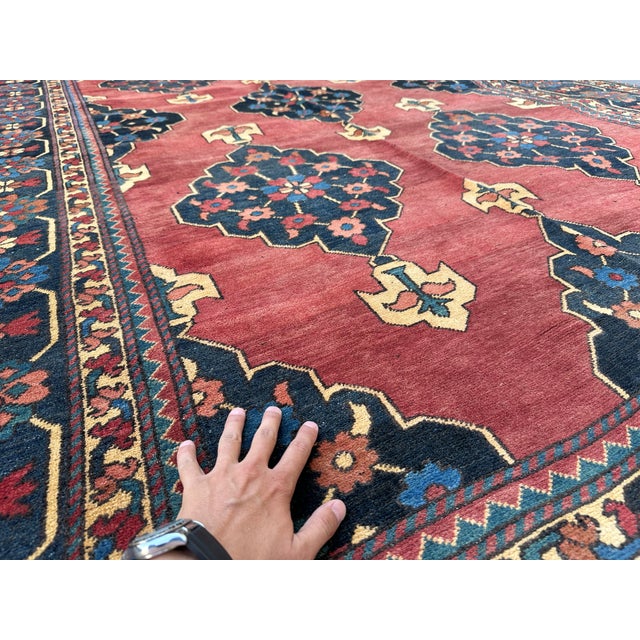 This Persian Karaja Heriz rug features the region's signature design: bold elongated diamond medallions, densely filled...