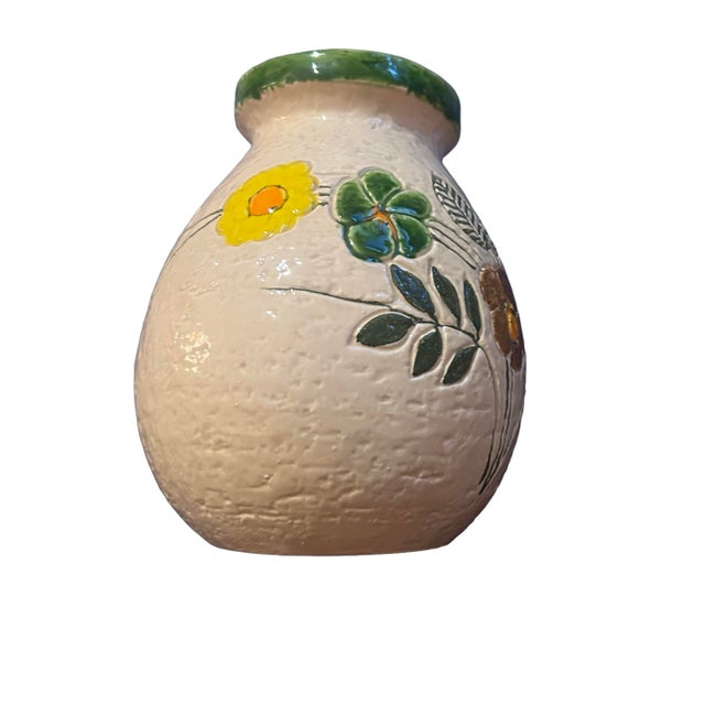 Bright and lovely vintage Bitossi vase by Aldo Londi. Features incised flowers and foliage on a off-white background with...