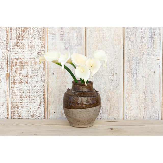 This small antique ceramic pot is original from the Martaban era of Burma. It features a wide opening used to store food...