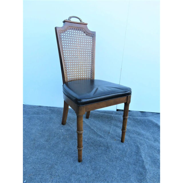 Regency Style side chair. Fruitwood frame with faux bamboo front legs, caned back with brass handle on crest, black vinyl...