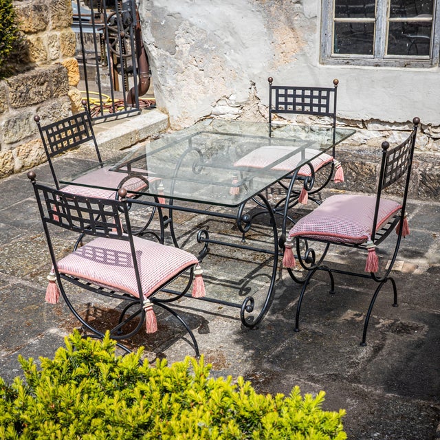 Garden seating set in iron consisting of a table with a rectangular glass top and four matching chairs in an antiqued...