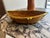 An elongated pencil reed basket with brass trim, crafted in Italy and shaped in a distinctive boat form. The woven...
