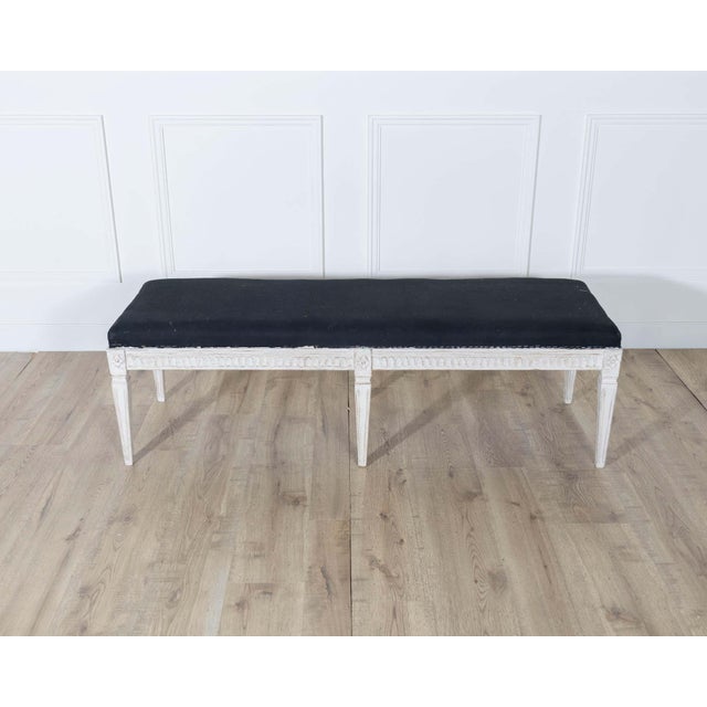 A refined Swedish bench dating to circa 1880, embodying the graceful elegance of the Neoclassical style. The frame is...
