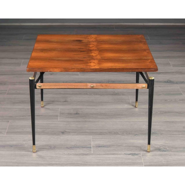 This Italian cocktail table features a square top veneered in rosewood, composed of eight panels laid to radiate...