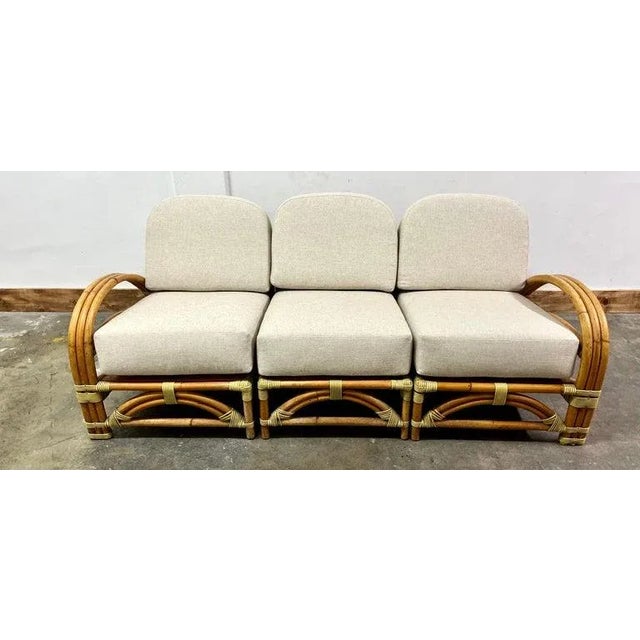 Ritts and Co. Rattan sofa with new raw cotton upholstery. The sofas comes in three sections that are independent but form...