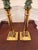 Elegant pair of vintage polished brass candlesticks featuring classic column-form stems and substantial square stepped...