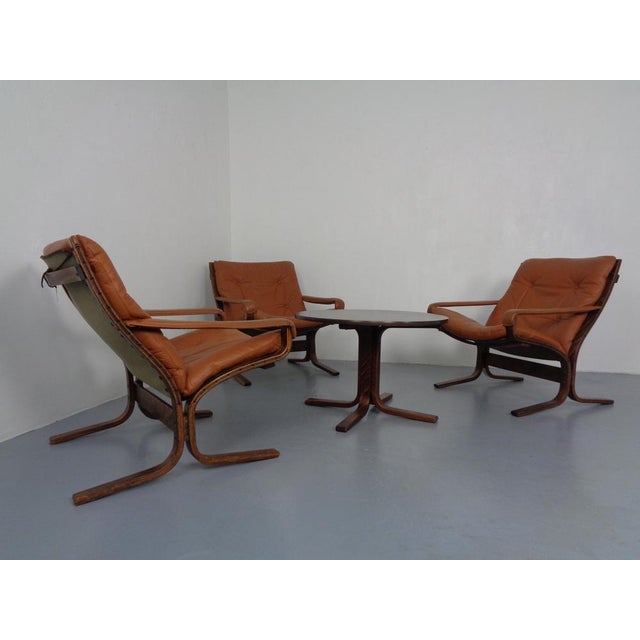 Living room ensemble consisting of 3 siesta armchair armchairs in cognac -colored leather and a table. Dimensions table:...