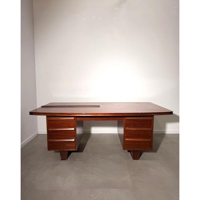 Impressive vintage executive desk crafted in richly toned mahogany, featuring a substantial architectural design typical...