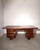 Impressive vintage executive desk crafted in richly toned mahogany, featuring a substantial architectural design typical...