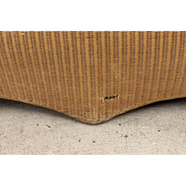 A Lloyd Loom loveseat. Lloyd Loom has a wonderful history of producing weather-resistant woven wicker-style furniture and...