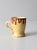 This vintage handmade studio pottery mug is finished in a warm golden glaze with expressive brown drips along the rim,...