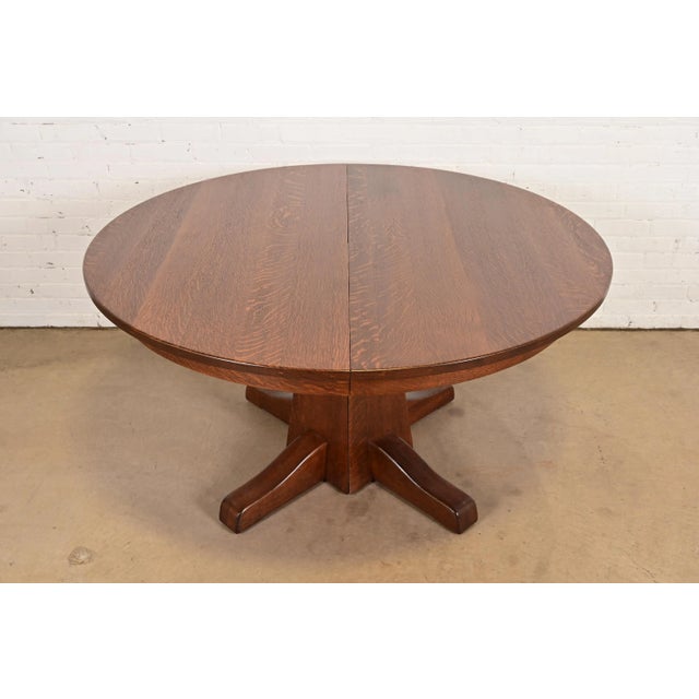 An outstanding Mission or Arts & Crafts period quarter sawn oak pedestal extension dining table By Charles P. Limbert Co....